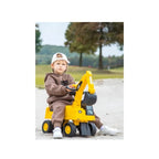 Toddler riding yellow excavator ride-on toy with bucket attachment and black wheels