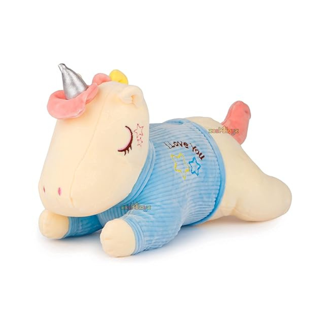 Lying unicorn plush toy in a blue jacket with embroidered stars