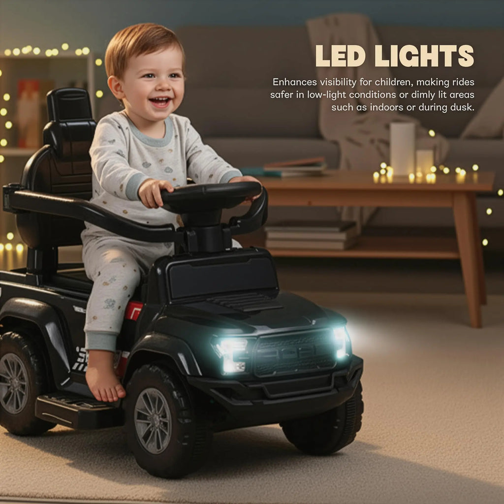 Black ride-on push car with a child at the wheel and glowing headlights