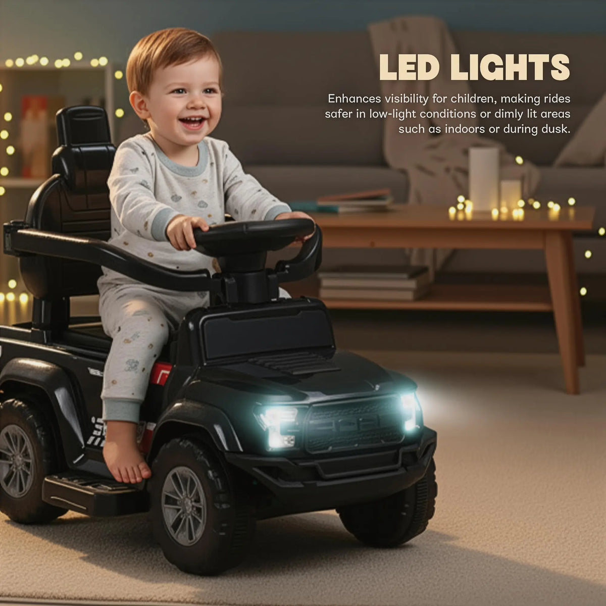 Black ride-on push car with a child at the wheel and glowing headlights