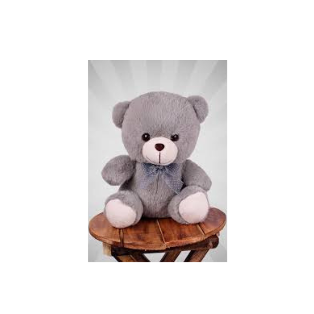 Tickles gray teddy bear plush with a blue bow and pale paws, seated upright.