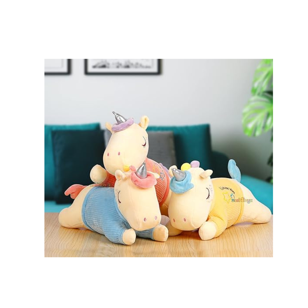 Three lying unicorn plush toys in yellow, blue, and coral jackets
