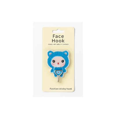 Blue bear-shaped face hook on a beige card with text