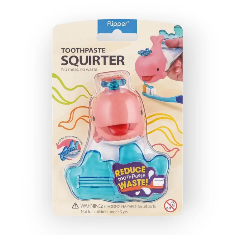 Flipper Toothpaste Squirter in its original retail packaging, featuring a pink whale-shaped toothpaste dispenser with a blue suction cup and a blue whale-shaped base.