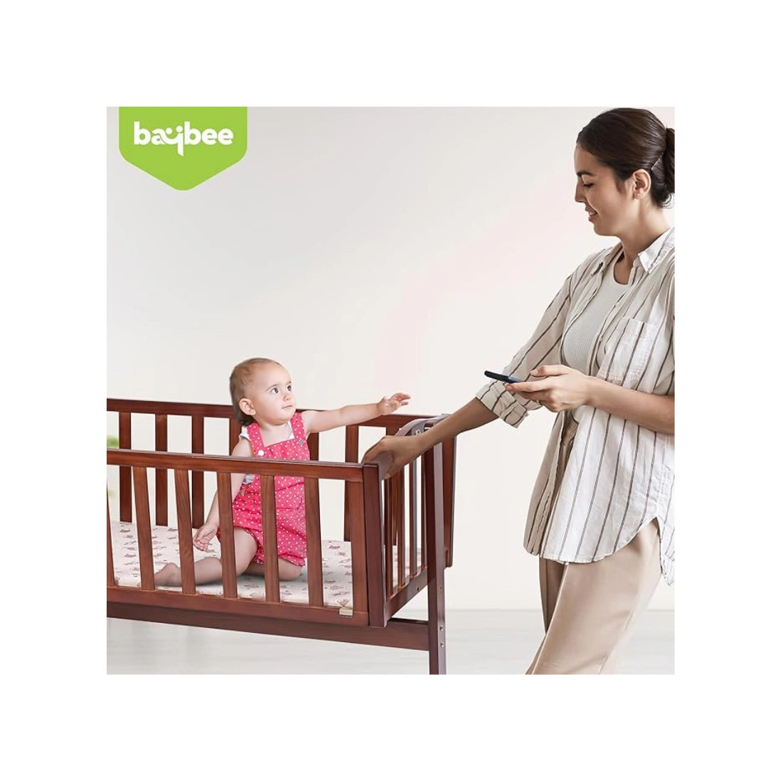 Wooden baby cradle with swing feature
