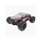 Remote control 4WD monster truck driving off-road on rough terrain.