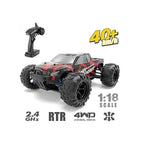 Remote control 4WD monster truck driving off-road on rough terrain.