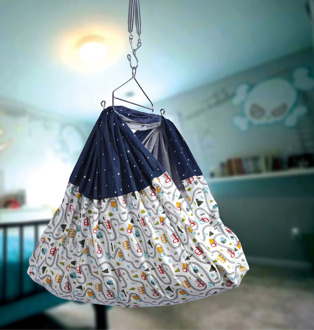 Printed crib cloth bundle with navy and white rolls, hanging on a metal hook