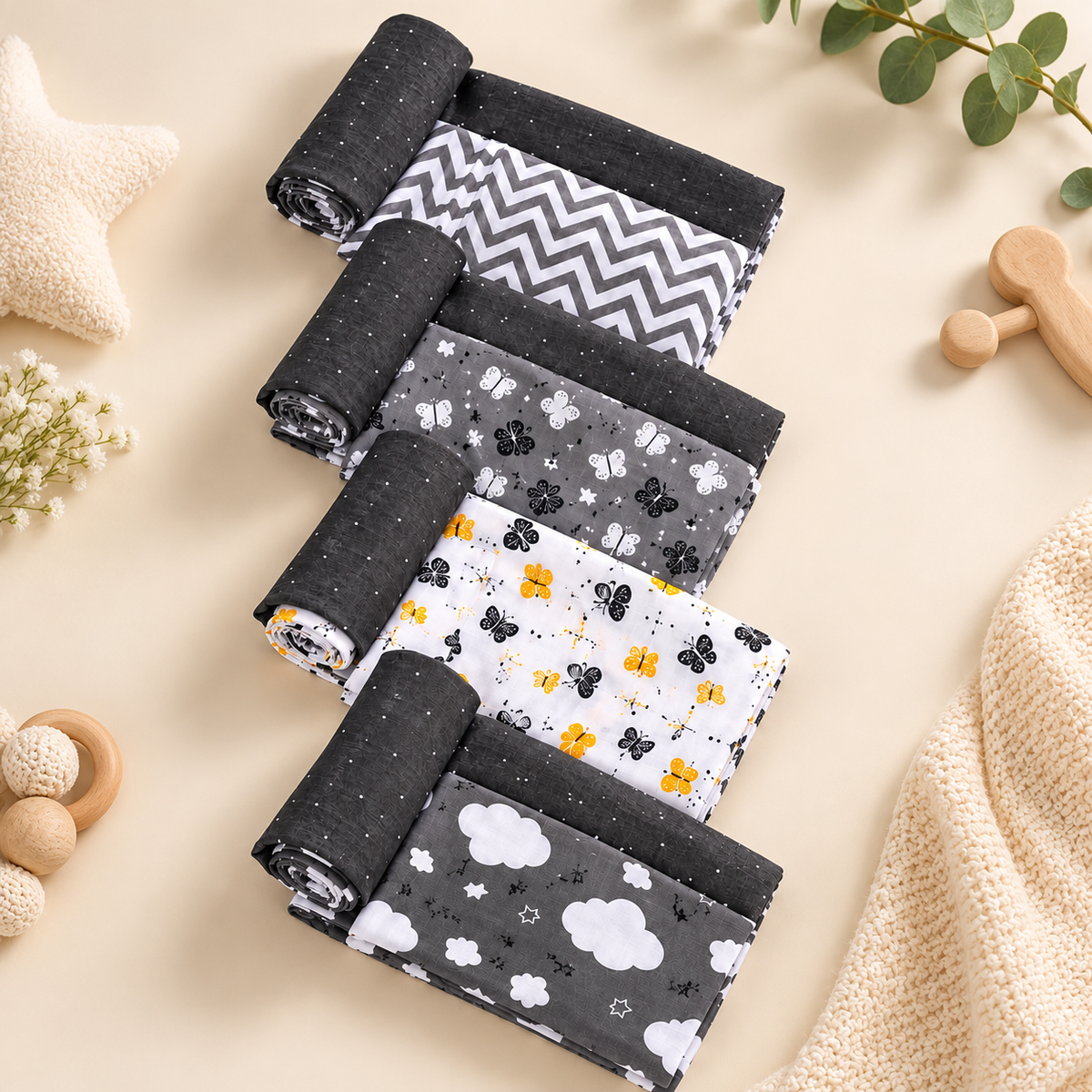 Folded crib cloth set with dark gray speckle, chevron, cloud, star and bee prints