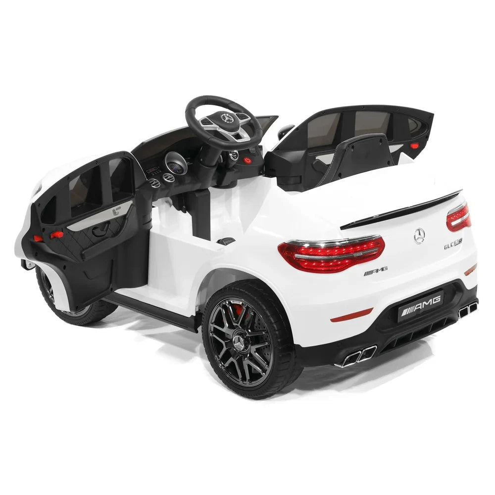 White Mercedes-Benz AMG ride-on car with open doors, rear lights, and black wheels