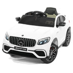 White Mercedes-Benz AMG ride-on car with front grille, LED headlights, and windshield