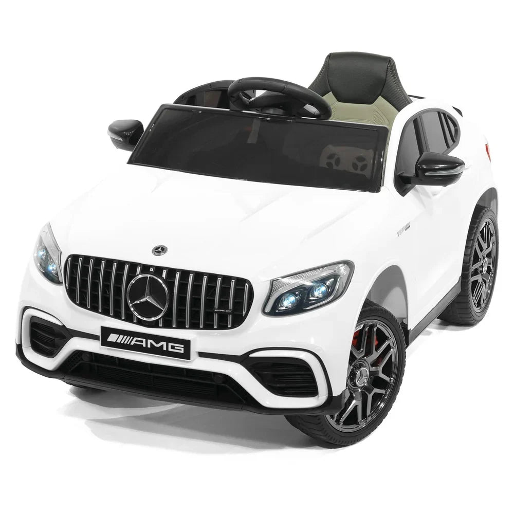 White Mercedes-Benz AMG ride-on car with front grille, LED headlights, and windshield