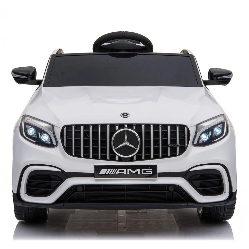 Front view of white Mercedes-Benz AMG ride-on car with grille badge and dual headlights