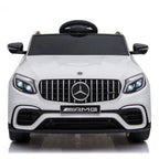 Front view of white Mercedes-Benz AMG ride-on car with grille badge and dual headlights