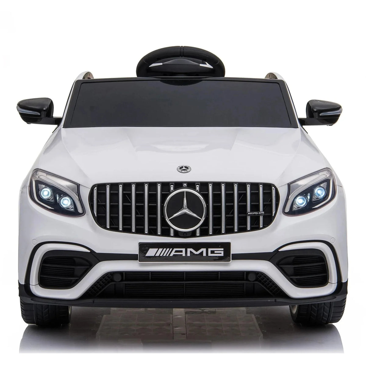 Front view of white Mercedes-Benz AMG ride-on car with grille badge and dual headlights