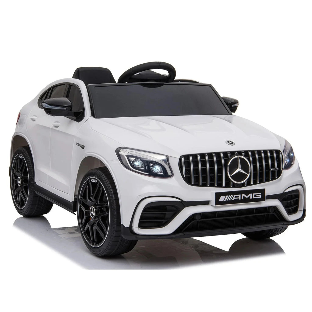 White Mercedes-Benz AMG ride-on car side view with black wheels and front headlight