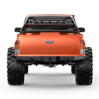 Orange RC rock crawler truck rear view with black bumper and four knobby tires