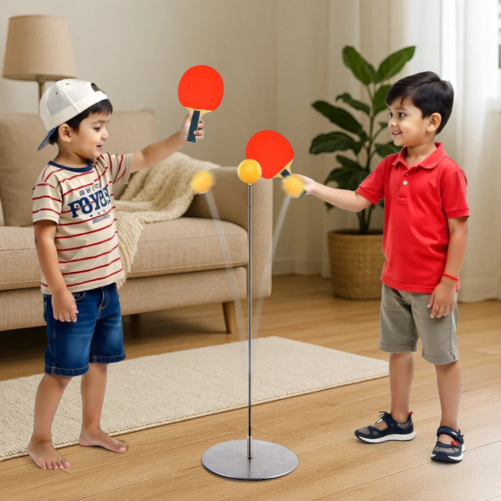 Child and kid playing table tennis training stand with red and orange paddles