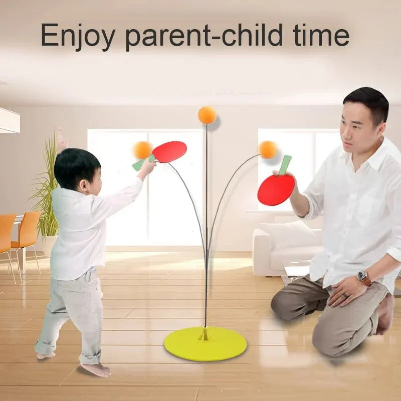 Parent-child ping pong practice stand with red and green paddles and orange balls