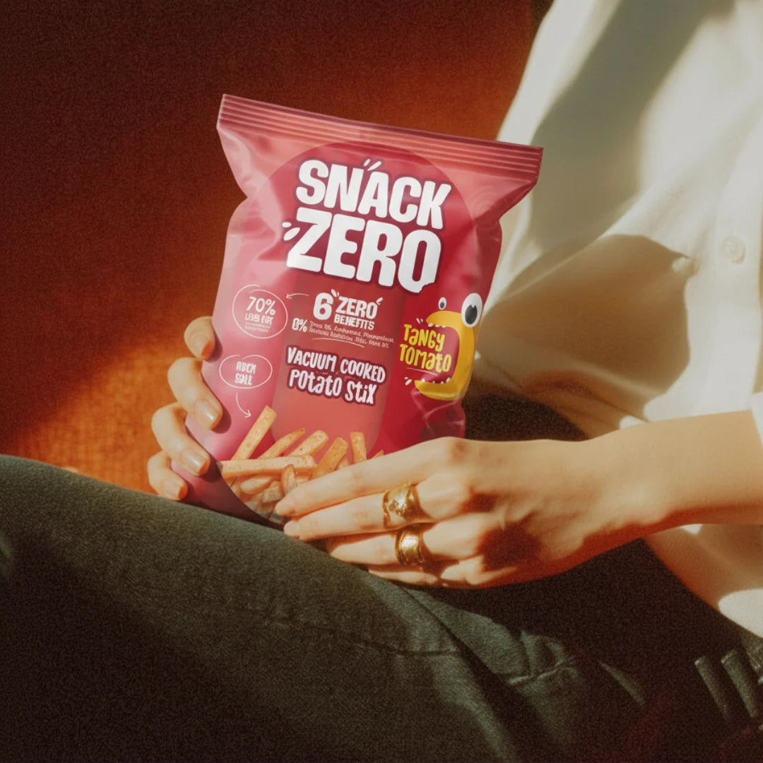 Snack Zero Tangy Tomato potato sticks bag held in hands with visible fries