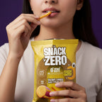 Snack Zero sweet potato stix classic cheese bag held by person, with a chip bite.